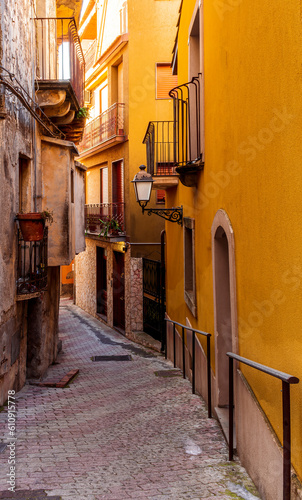 beautiful narrow medeterranean street with vintage buildings , beautiful windows and picturesque balcony with attributes of traditional italian country life © Yaroslav
