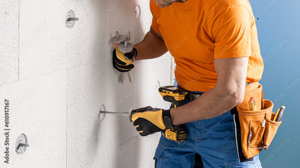 Inserting a dowel for thermal insulation to the drilling hole in the mineral insulation board. Inserting a dowel for thermal insulation to the drilling hole in the mineral insulation board.