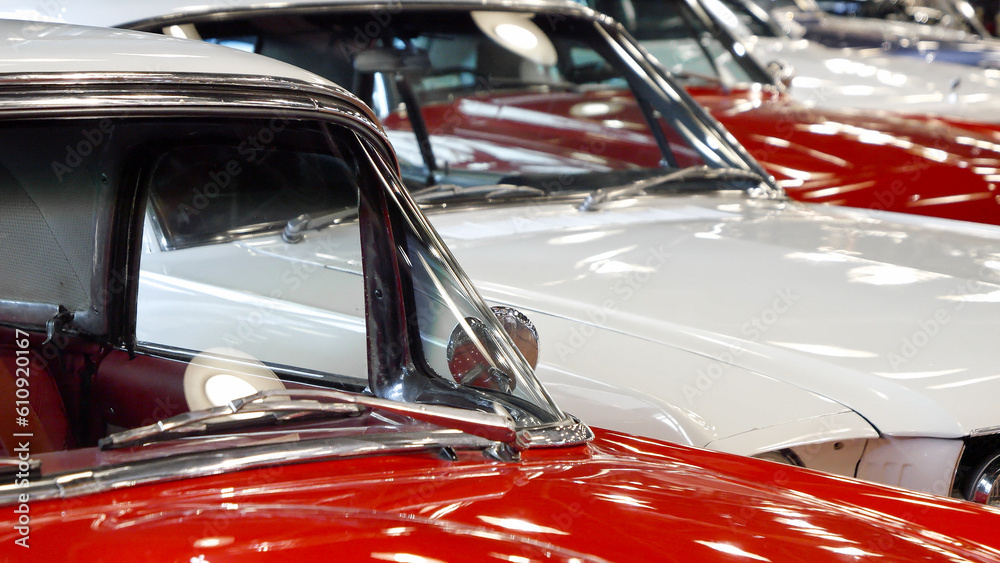 Dolly shot of vintage retro car hoods painted in red and white. Old transport exhibition or auction