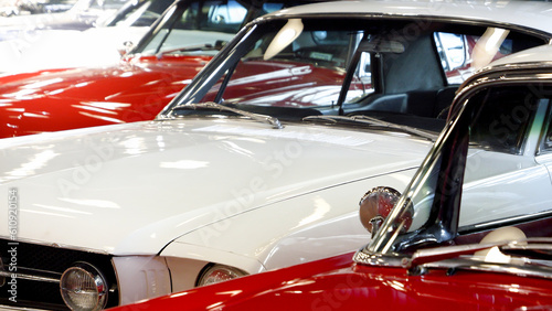 Closeup of retro cars pained in red and white. Details of automobiles.