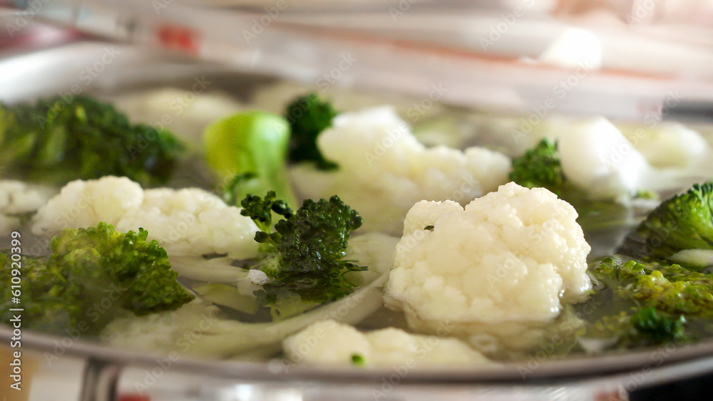 Closeup of woman closing boiling soup with glass lid. Concept of healthy eating, organic food, vegan and vegetarian Closeup of woman closing boiling soup with glass lid. Concept of healthy eating, organic food, vegan and vegetarian