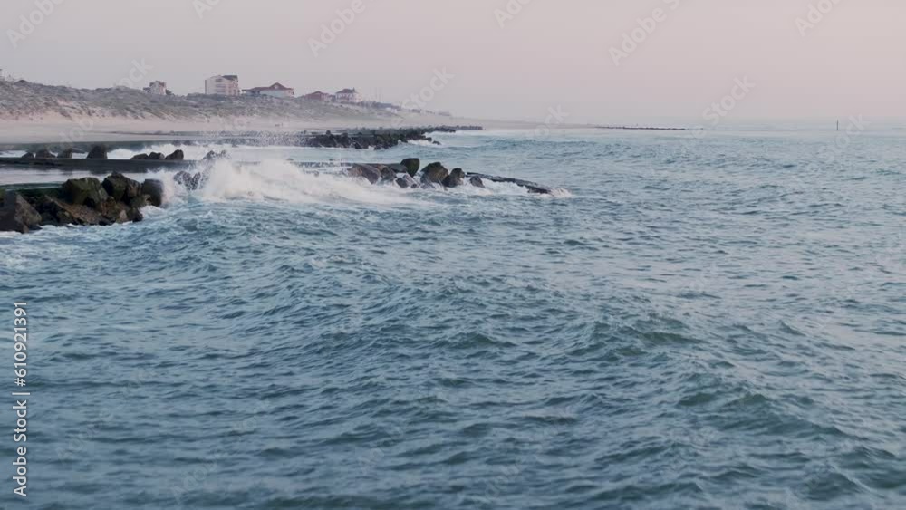 Ocean wave barrier pools at Les Huttes, Soulac western France, Aerial Flyover low shot