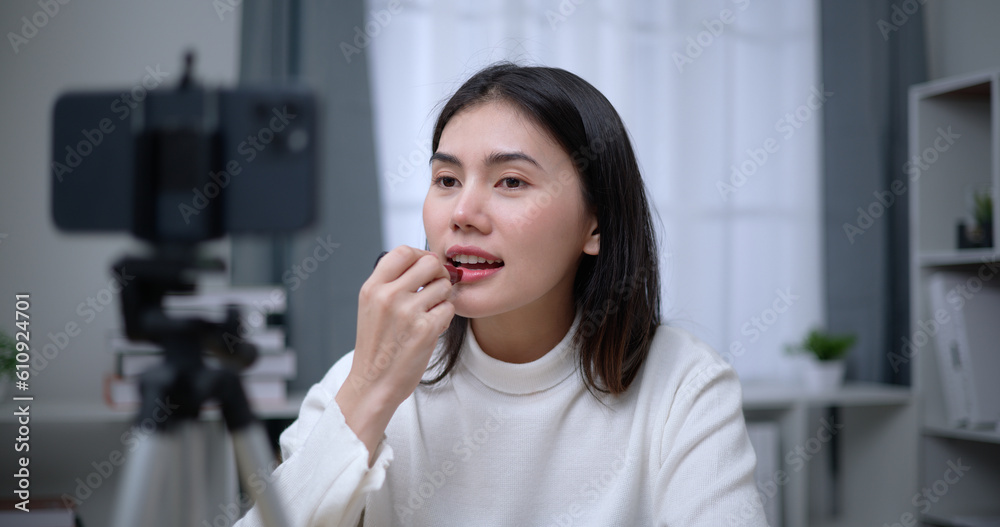 Beautiful young Asian woman blogger shows how to make up cosmetics at home Beautiful young Asian woman blogger shows how to make up cosmetics at home