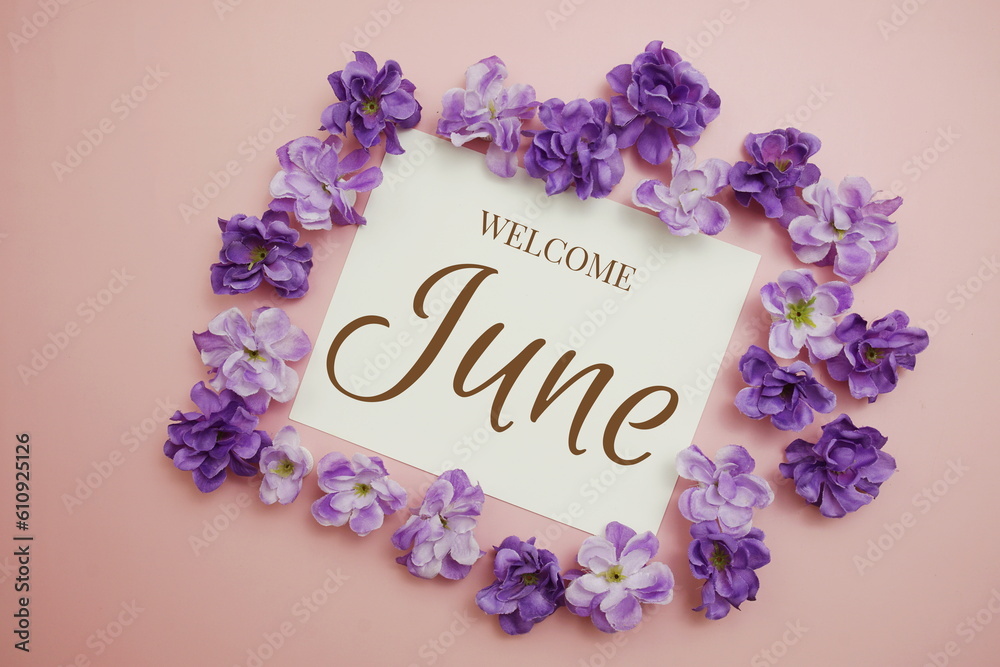 Fototapeta premium Welcome June card typography text with flower bouquet on pink background