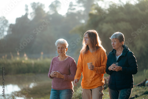 family of senior woman and teenager talking about activity recreation and picnic while coffee breakfast together in morning weekend, camping travel vacations trip in holiday, outdoor leisure party