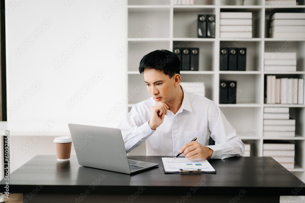 Businessman using tablet and laptop for doing math finance on an office desk, tax, report, accounting, statistics, and analytical research concept in office Businessman using tablet and laptop for doing math finance on an office desk, tax, report, accounting, statistics, and analytical research concept in office