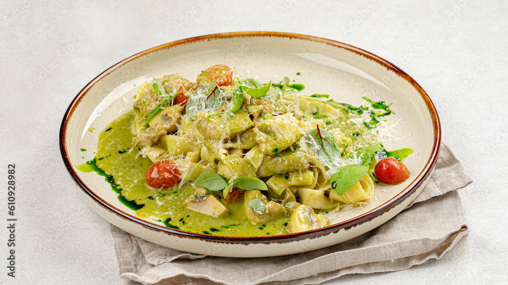 Portion of gourmet pasta fettuccine with pesto sauce Portion of gourmet pasta fettuccine with pesto sauce