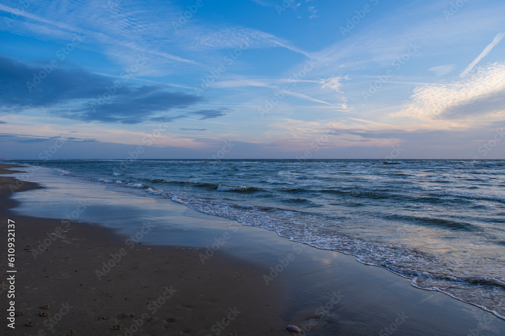 Walk in the evening on the beach of the Dutch North Sea near Egmond aan Zee/NL