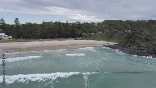 Surfers In Flynns Beach On A Cloudy Day In Port Macquarie, Australia - aerial drone shot photo