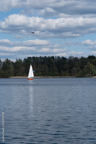 Small boat with white sheet on a lake in Lithuania
