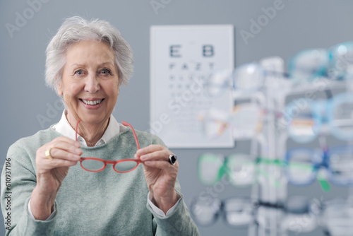 Happy senior woman trying new prescription glasses