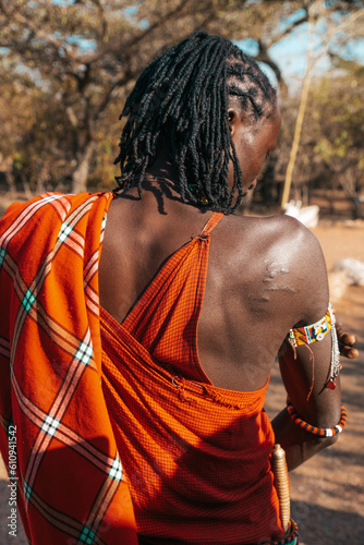 Colourful maasai warrior with visible scar from a lion attack