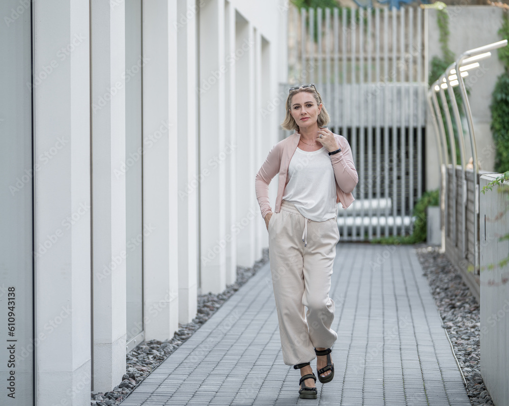 Portrait of Beautiful White Caucasian Adult Woman She is Wearing Active Lifestyle Outdoor Sportwear. Vilnius, Lithuania. White t-shirt. Portrait of Beautiful White Caucasian Adult Woman She is Wearing Active Lifestyle Outdoor Sportwear. Vilnius, Lithuania. White t-shirt.