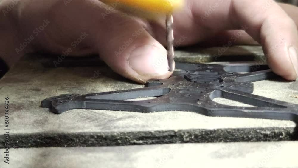 hands drilling a steel plate with a column drill hands drilling a steel plate with a column drill