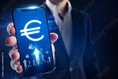 Euro growth concept. Businessman follows the growth of the dollar through a mobile app