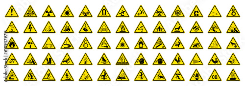 Big Set of 65 isolated hazardous symbols on yellow round triangle board warning sign photo