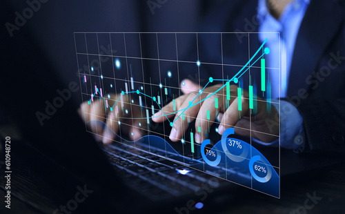 Stock exchange market investment concept. Business person following business trend candle chart finacial data on laptop interface vertual screen. Business strategy. photo