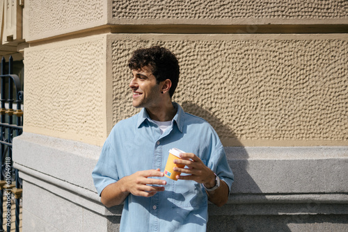 Young man in the street with coffee