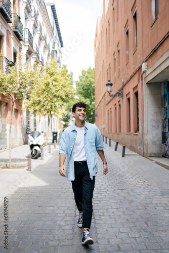 Young man with curly hair in the city