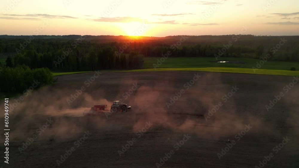 Vidéo Stock Drone flying over tractor with harrow system plowing ground ...