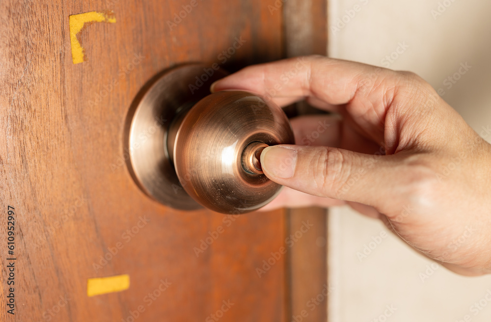Close up of a hand pressing a door lock, Concept of safety. Close up of a hand pressing a door lock, Concept of safety.