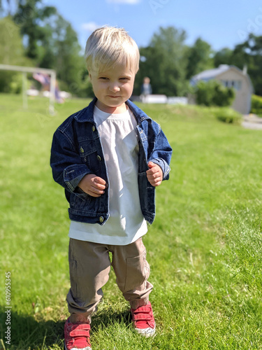 cute boy child in a denim jacket in the park
