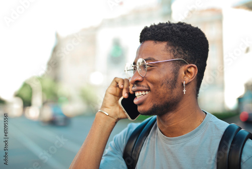young man talks on the phone on the street