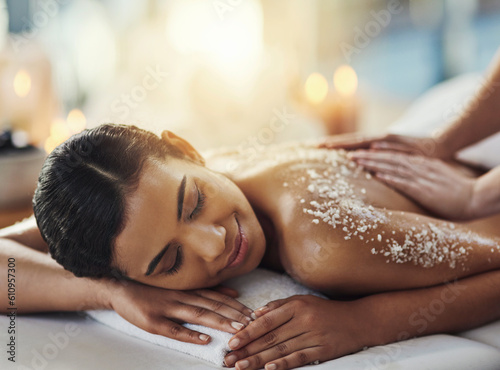 Happy woman, salt scrub and massage back at spa to relax for skincare, exfoliation or self care. Female person, beauty and smile for luxury body treatment, health and wellness with masseuse at salon photo
