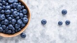 Fresh delicious blueberries on dark stone background, top view, flat lay, generative ai