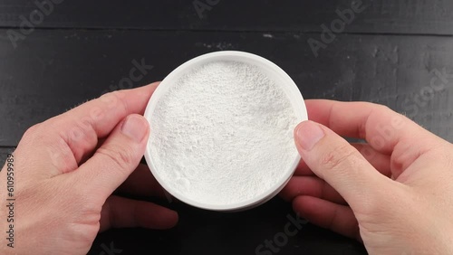 Tooth powder in a jar in hands
