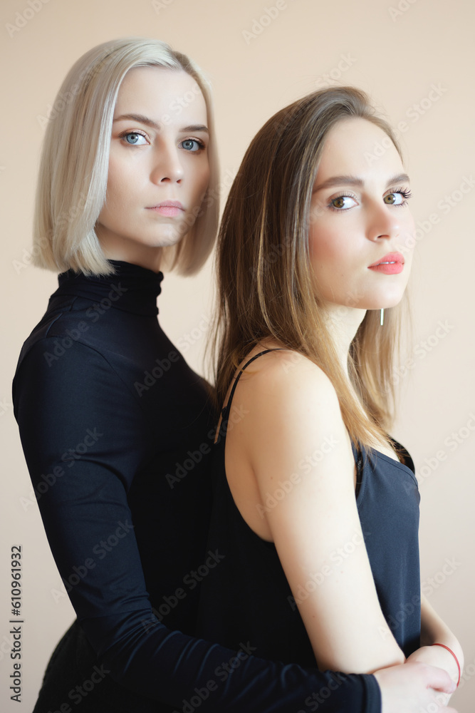 View of two young women on a light background. View of two young women on a light background.