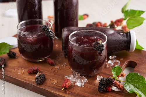 Mulberry Shrub, Juice or liqueur in glass bottles, mulberry juice for health, reduce cholesterol, control blood sugar, antioxidants, nourish the brain, cancer prevention, stimulates blood flow. photo