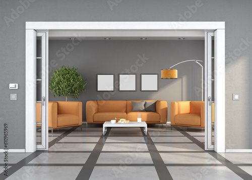 Fotografía Sliding door in living room with sofa and orange armchairs in the background