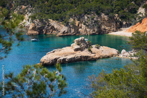 People sunbathe on Galley rock or Submarine rock. View  from hiking path near Calanque de Port d'Alon (between Saint-Cyr-sur-Mer and Bandol), France. Unique shapes of nature. Travel background
