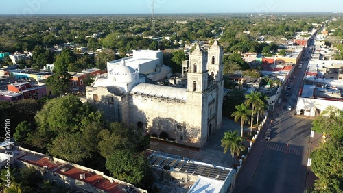 Aerial to left showing Cathedral de San Gervasio and the city beyond after sunrise in Valladolid, Yucatan, Mexico. photo
