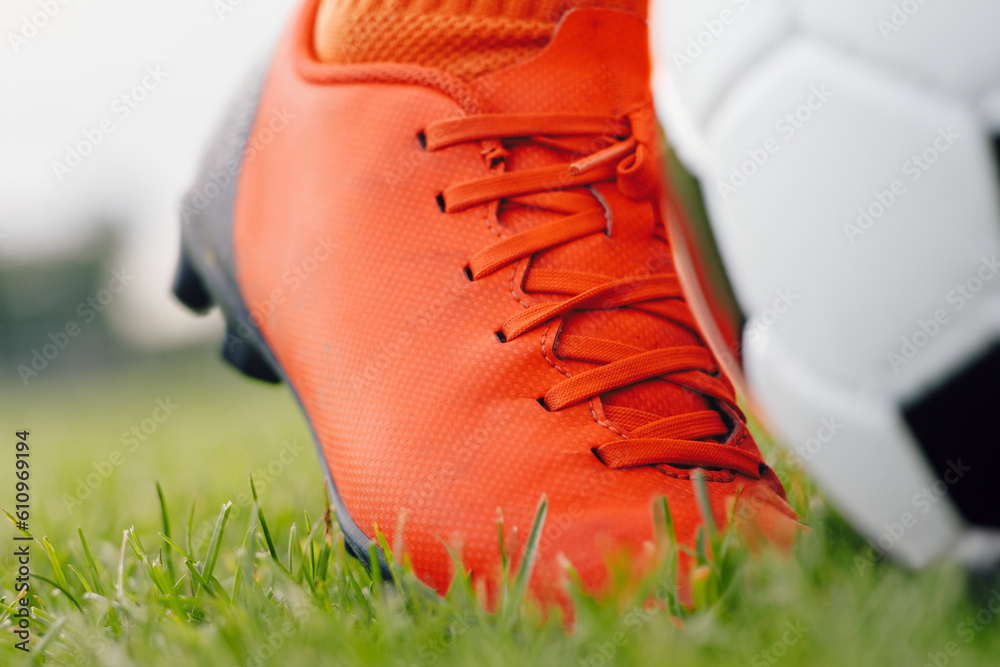 Football soccer ball at the kickoff of a game. Soccer player wearing