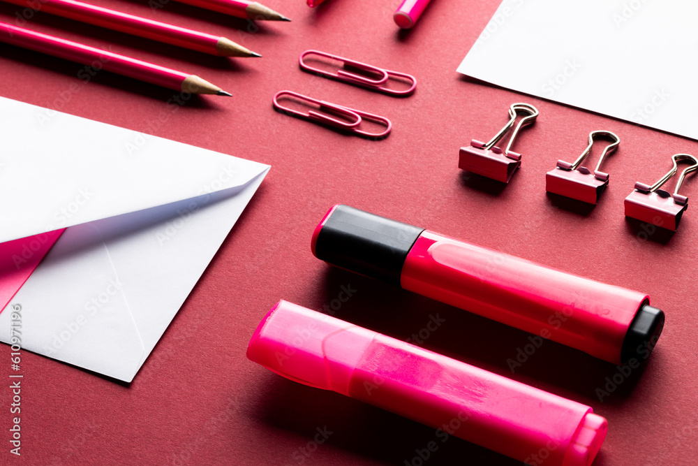 Flat lay of white papers with copy space and school materials on red background Flat lay of white papers with copy space and school materials on red background
