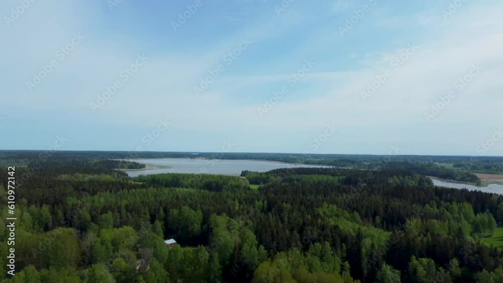 The enchanting scene unfolds as a lush forest meets the tranquil expanse of water under a vast and captivating sky. The enchanting scene unfolds as a lush forest meets the tranquil expanse of water under a vast and captivating sky.