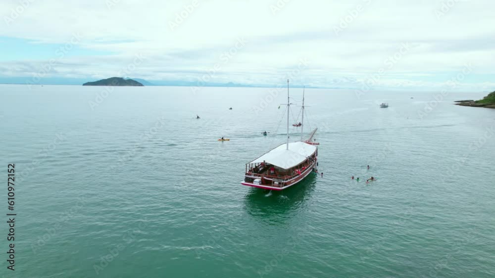 Aerial orbit of tourist boat on the Tartaruga beach shoreline, Brazil Aerial orbit of tourist boat on the Tartaruga beach shoreline, Brazil