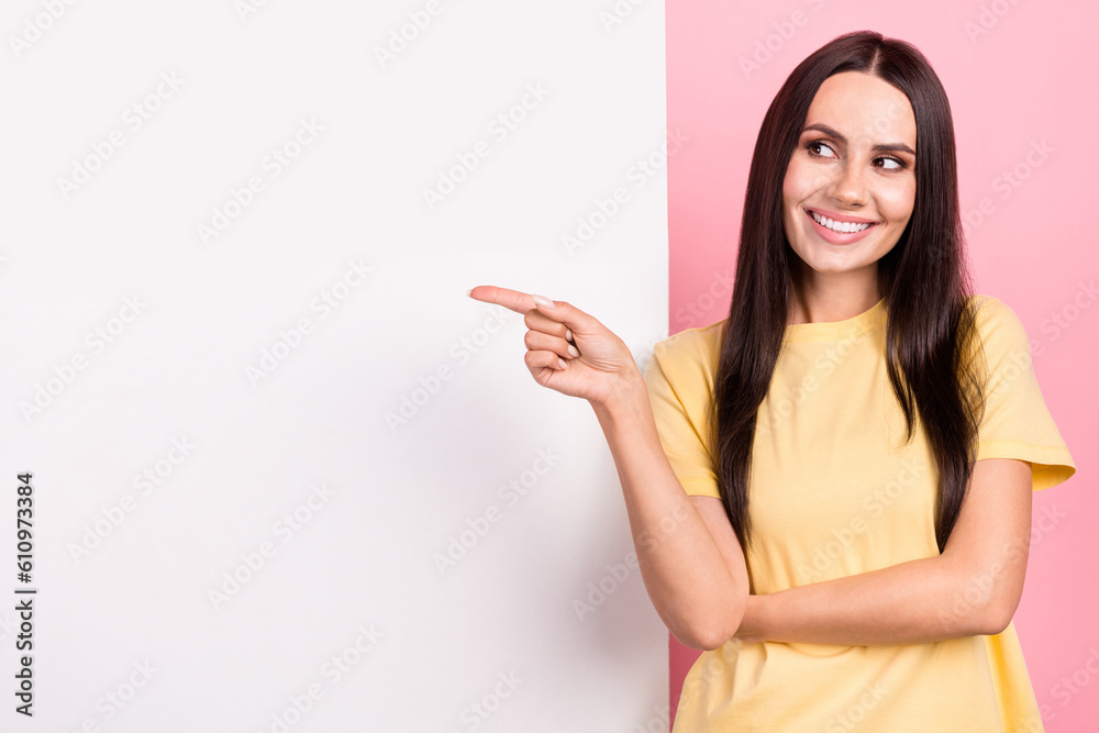 Photo of pretty dreamy woman dressed yellow t-shirt looking showing poster empty space isolated pink color background Photo of pretty dreamy woman dressed yellow t-shirt looking showing poster empty space isolated pink color background