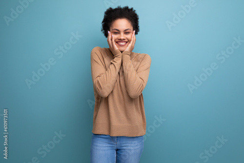 happy joyful young woman with swarthy skin and fluffy hair over isolated background with copy space