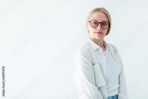 Serious teacher in eye glasses with a book. Smart woman, education concept