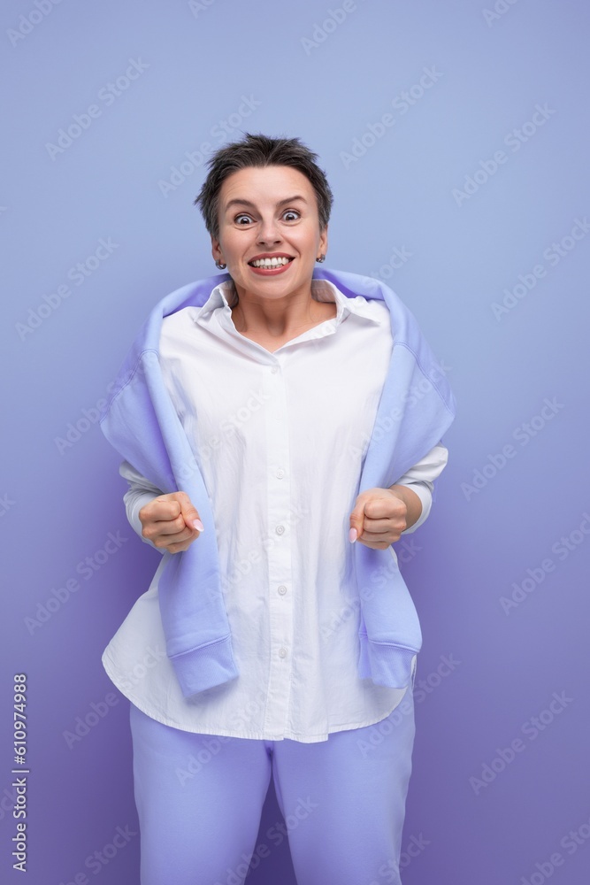 portrait of energetic cheerful young millennial woman with short haircut smiling