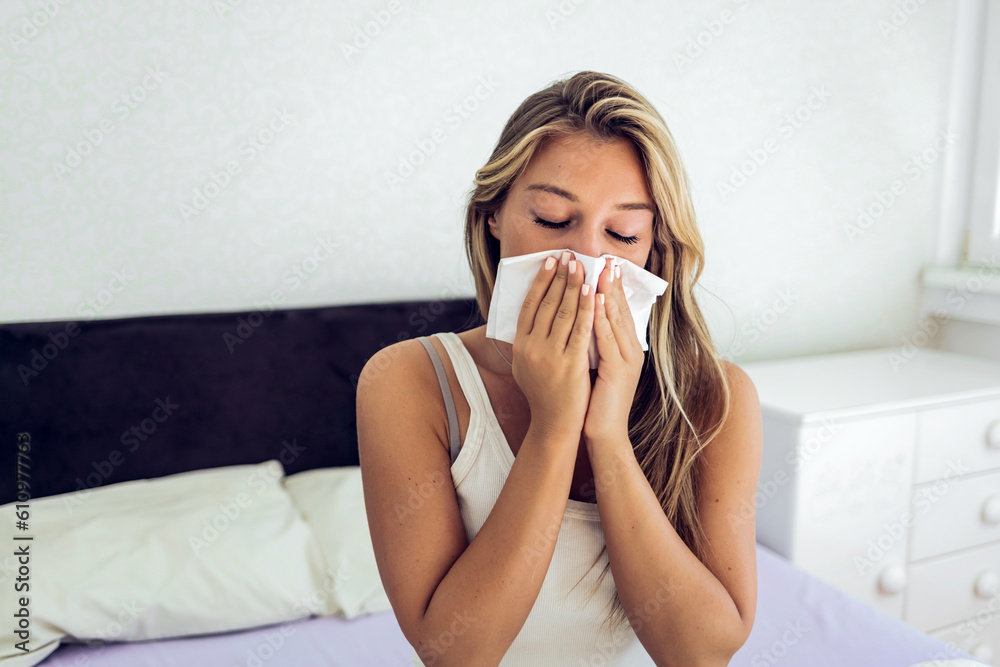 Sick woman covered with a blanket sitting in bed with high fever and flu, resting at bedroom. She is exhausted and suffering from flu. Sick woman with runny nose lying in bed. Girl suffering from cold Sick woman covered with a blanket sitting in bed with high fever and flu, resting at bedroom. She is exhausted and suffering from flu. Sick woman with runny nose lying in bed. Girl suffering from cold