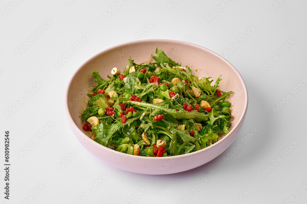 Green salad with goji berries and broccoli in a plate Green salad with goji berries and broccoli in a plate