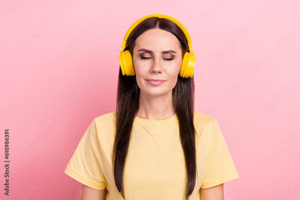Photo of shiny dreamy woman dressed yellow t-shirt headphones closed eyes enjoying songs isolated pink color background Photo of shiny dreamy woman dressed yellow t-shirt headphones closed eyes enjoying songs isolated pink color background