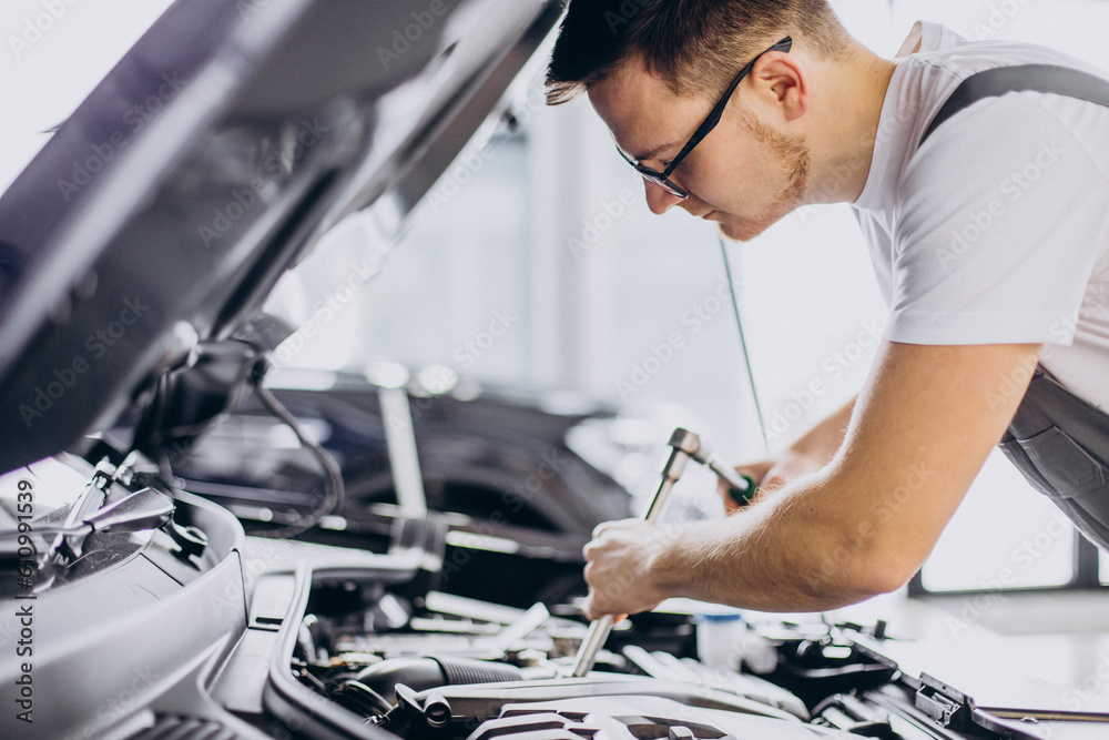 Repair man making car service Repair man making car service