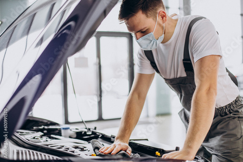 Repair man making car service