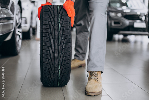 Mechanic changing tires in a car service