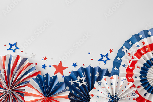 Idea for patriotic festivities on Independence Day. Top view flat lay of american paper props, red, blue, white stars on white background with blank space for advert or message